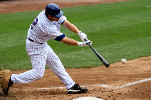 A baseball player just after hitting the ball.