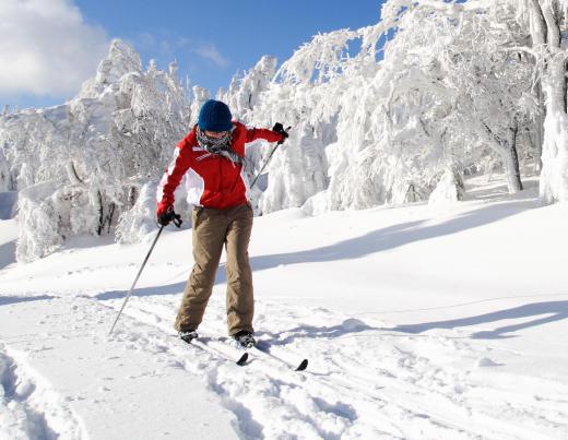 Cross country skiing involves using skiis and poles to cross terrain.
