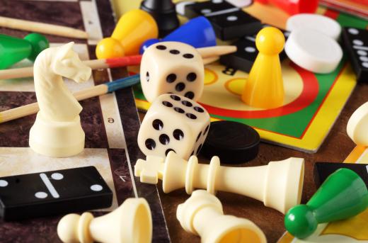 Board games often have tokens, pawns, dice, cards, or other playing pieces that are used in specific ways throughout the game.