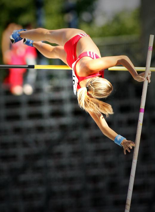 Pole vaulters contort their bodies to maximize the heights they can reach.