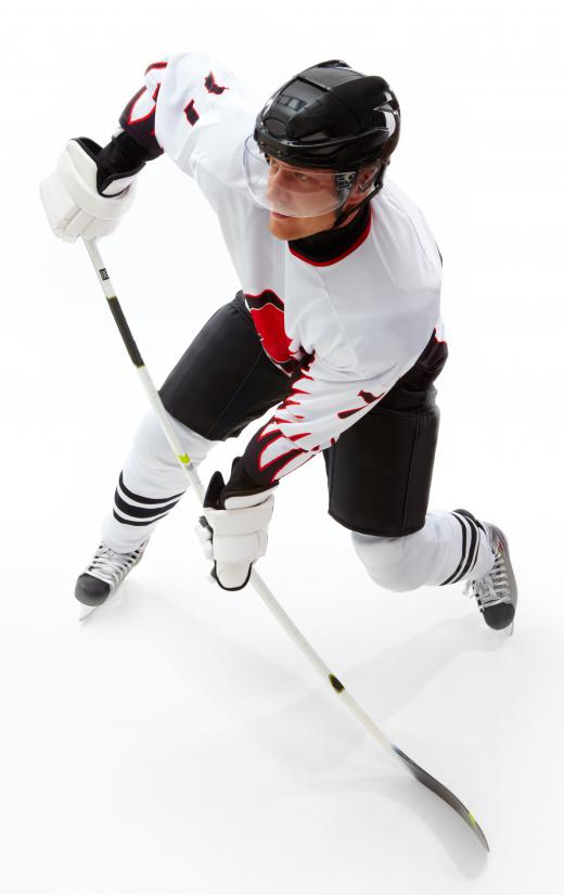 Hockey player wearing hockey skates.