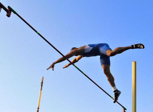 An individual must jump over a raised horizontal bar without knocking it down during the high jump.