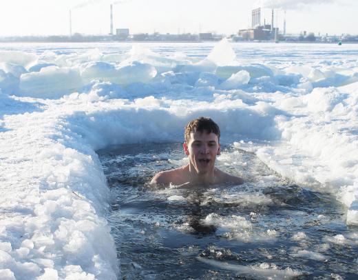When ice swimming in bodies of water outdoors, people must make a hole in the top crust of ice.