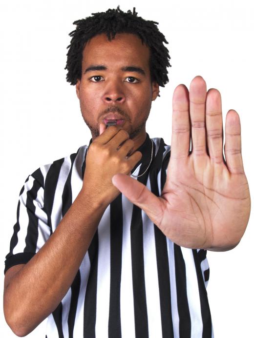 A soccer referee may use hand signals to indicate a ruling.