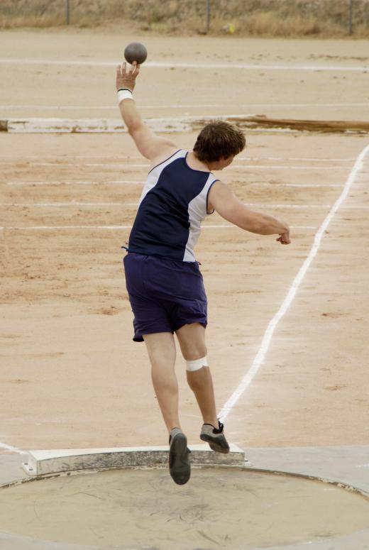 Shot putters wear track spikes while they practice.