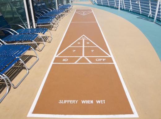 The most traditional form of shuffleboard takes place on large courts, where players push pucks across a scored game board.