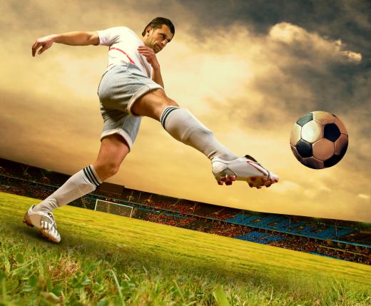 A soccer player kicking the ball.