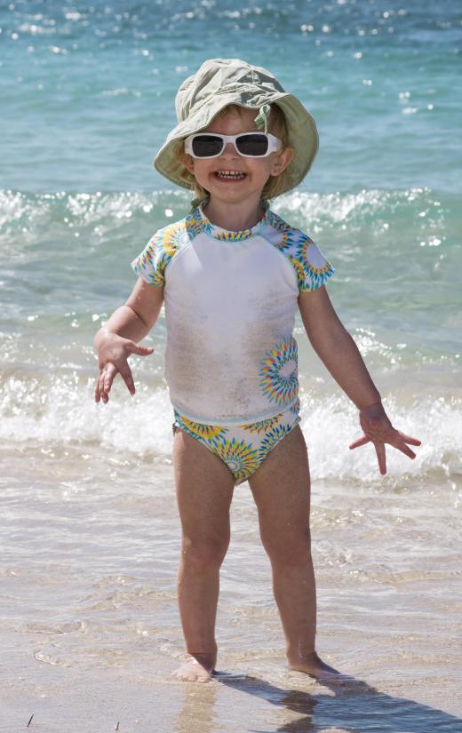 A young child wearing a rash guard.